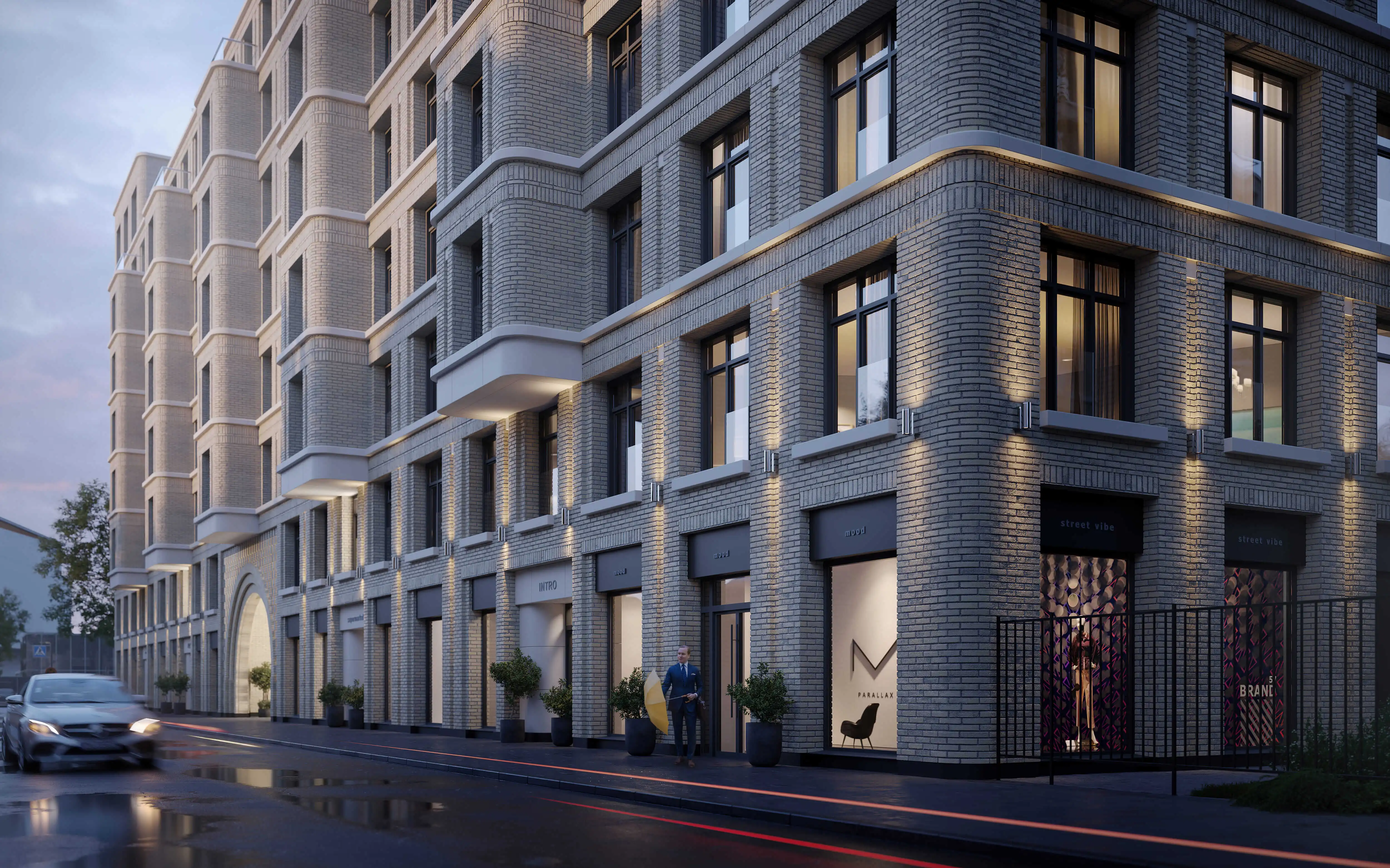 Вечерний вид на клубный дом «Визионер» с эффектной архитектурной подсветкой, современные фасады и коммерческие помещения на первом этаже